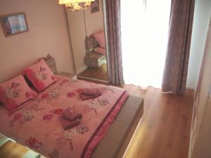 斯特拉斯堡Le Carré des oiseaux的一间卧室配有一张带粉色床单和镜子的床