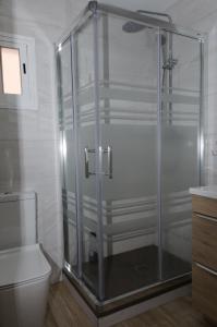 马德里Moderno,tranquilo, entrada autónoma y fácil aparcamiento.的一间带卫生间的浴室内的玻璃淋浴间