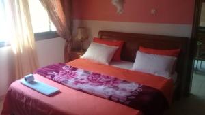 达喀尔卡兰奎斯公寓式酒店的一间卧室配有一张带盒子的床