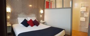 诺亚芒提亚La Villa en L'île - 2 Piscines & Spa的一间卧室配有红色和黑色枕头的床