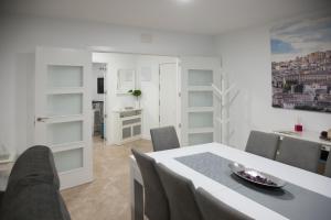 托莱多Apartamento 4Bedrooms的白色的用餐室配有桌椅