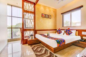 博帕尔FabHotel The Khushi Regent的一间卧室设有两张床和窗户。