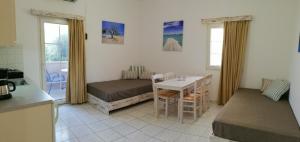 库基尼坎尼奥Evina Rooms & Suites的小房间设有一张床、一张桌子和椅子