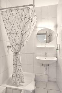 美因茨莫古缇娜酒店的白色的浴室设有水槽和镜子