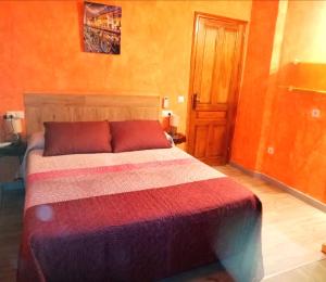 ChertCasa con jacuzzi la olivera的一间卧室配有一张带彩色床罩的床