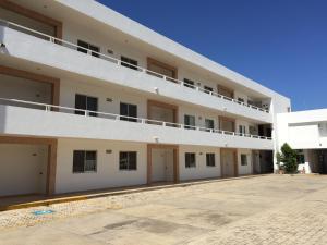 坎佩切Hotel Villa Campeche的一座大型白色公寓大楼,设有停车场