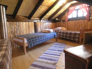 BrdaHolz Haus Banja Luka的小木屋内一间卧室,配有两张床