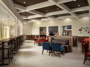 欧文欧文达拉斯/沃斯堡机场北智选假日酒店及套房的一间带桌椅的餐厅和一间酒吧
