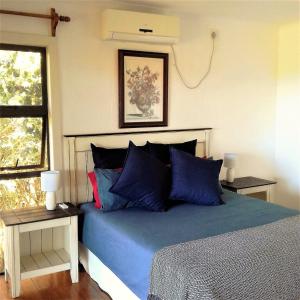 Ponta MalanganeAlfies House的一间卧室设有蓝色的床和窗户。
