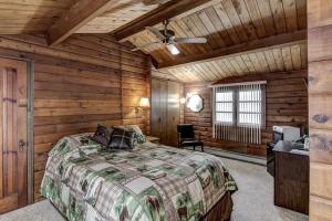 Rib LakeRib Waters Inn的卧室配有一张床铺,位于带木墙的房间内