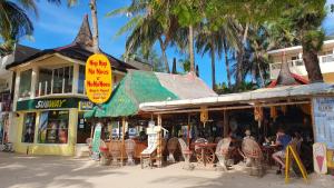 长滩岛尼吉尼吉努诺斯努努诺斯的一间设有桌椅的餐厅,种植了棕榈树