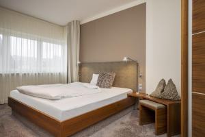 安德纳赫爱姆黑沃特斯图穆酒店的一间卧室配有一张床、一张桌子和一个窗户。