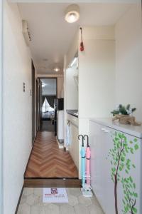 京都Cozy house 31, free wifi a rented electric bicycle的走廊通往厨房,走廊通往房子