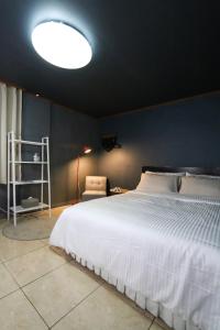 大邱Seong Dong Jang的卧室配有白色的床和蓝色的墙壁