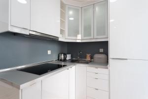 里斯本FLH Mouraria Charming Flat II的白色的厨房配有白色橱柜和水槽