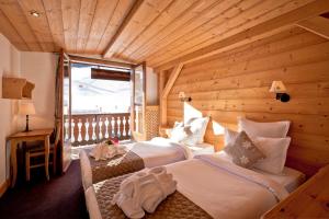 谷雪维尔雷斯福洛肯斯酒店的木制客房内的一间卧室配有两张床