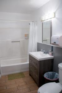 洛杉矶梅尔罗斯旅舍的一间带水槽、浴缸和卫生间的浴室
