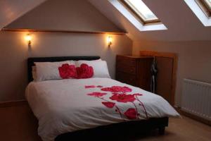 都柏林killowen的一间卧室,床上有红色玫瑰