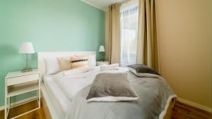 Apartamenty Sun & Snow Triventi Mountain Residence客房内的一张或多张床位