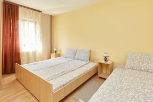 索科矿泉村Apartmani Stojadinović的一间卧室设有一张大床和一个窗户。