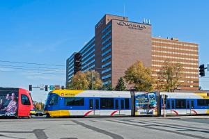 布卢明顿Crowne Plaza Suites MSP Airport的一条蓝色和黄色的火车在城市街道上