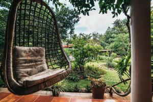 迈索尔Gitanjali Homestay的花园门廊上的吊椅