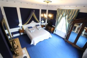 克斯米奇斯米城堡酒店的蓝色的卧室设有床和大窗户