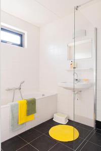 VlagtweddeHebrechthuis的带淋浴的浴室和黄色地毯