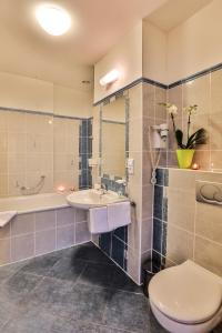 布拉格普拉哈阿卡达酒店的浴室配有卫生间、盥洗盆和浴缸。