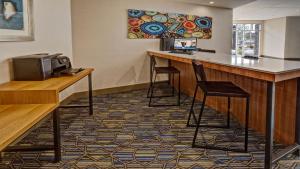 路易斯威尔路易斯维尔机场展览中心智选假日酒店的一间酒吧,位于酒店的房间,设有两个凳子