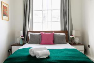 伦敦PickThePlace Lancaster gate的一间卧室配有一张床,上面有两条毛巾