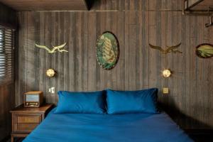 纳什维尔The Dive Motel and Swim Club的卧室配有蓝色的床,墙上有鸟儿