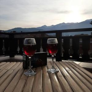 多布里尼什特Relax Dobrinishte的木桌旁放着两杯红葡萄酒