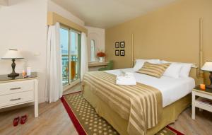 埃拉特Herods Palace Hotels & Spa Eilat a Premium collection by Fattal Hotels的一间卧室设有一张大床和一个窗户。