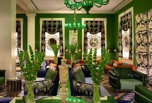 华盛顿摩纳哥华盛顿特区金普顿酒店的客厅设有绿色的墙壁和吊灯。