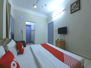 苏尔Super OYO 108 Marsa Al Masafar Hotel Apartment的一间卧室配有一张大床和电视