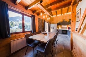 梅杰夫Close to the village - Chalet 4 Bedrooms, Mont-Blanc View的一间带木桌和椅子的用餐室