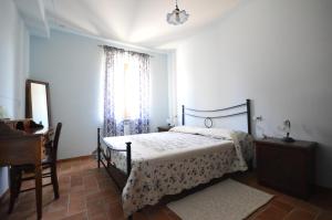 Beroide卡尔达瑞拉乡村民宿的一间卧室配有一张床、一个梳妆台和一扇窗户。