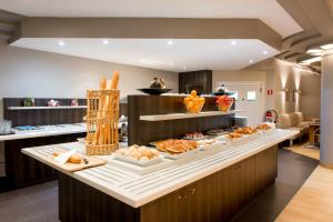 布鲁塞尔尚博尔酒店的厨房提供包括面包和糕点的自助餐