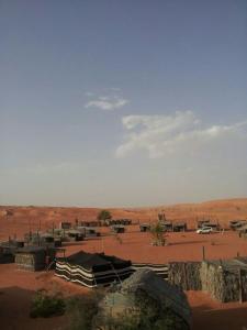 Al WāşilNomadic Desert Camp的帐篷和田野,享有沙漠美景