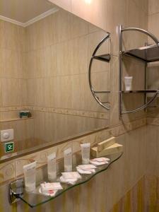 马拉茨基Hotel TATRA的浴室设有玻璃架和镜子