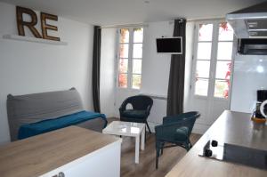 拉弗洛特Le Mole (Appartements et Chambres)的带沙发和椅子的小客厅