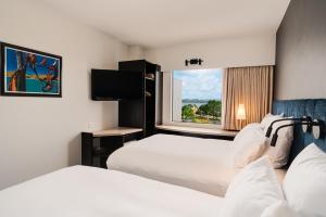 罗托鲁瓦罗托鲁阿宜必思酒店的酒店客房设有两张床和窗户。