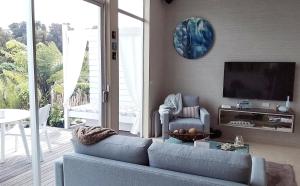 Pohara湾湾旅舍的客厅配有蓝色的沙发和电视