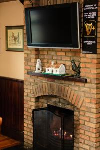 塔伯柯里叶芝县酒店的砖砌壁炉,上面配有电视