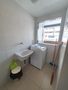 马塞约Rosa Branca Facilities Apartamentos的一间带水槽和洗衣机的浴室