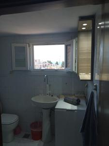 尼亚米卡尼奥纳DESPOINA APARTMENT 4 Relax的一间带水槽和卫生间的浴室以及窗户。