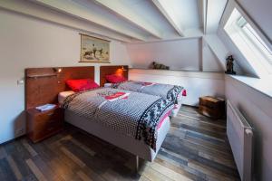 's-Graveland沙坑住宿加早餐旅馆 的一间卧室配有一张带红色枕头的床
