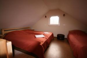 Lāde萨拉斯森林酒店的阁楼卧室设有两张床和窗户。