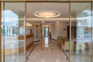 拉里萨Olympus Terra Boutique Hotel的建筑中带玻璃门的走廊